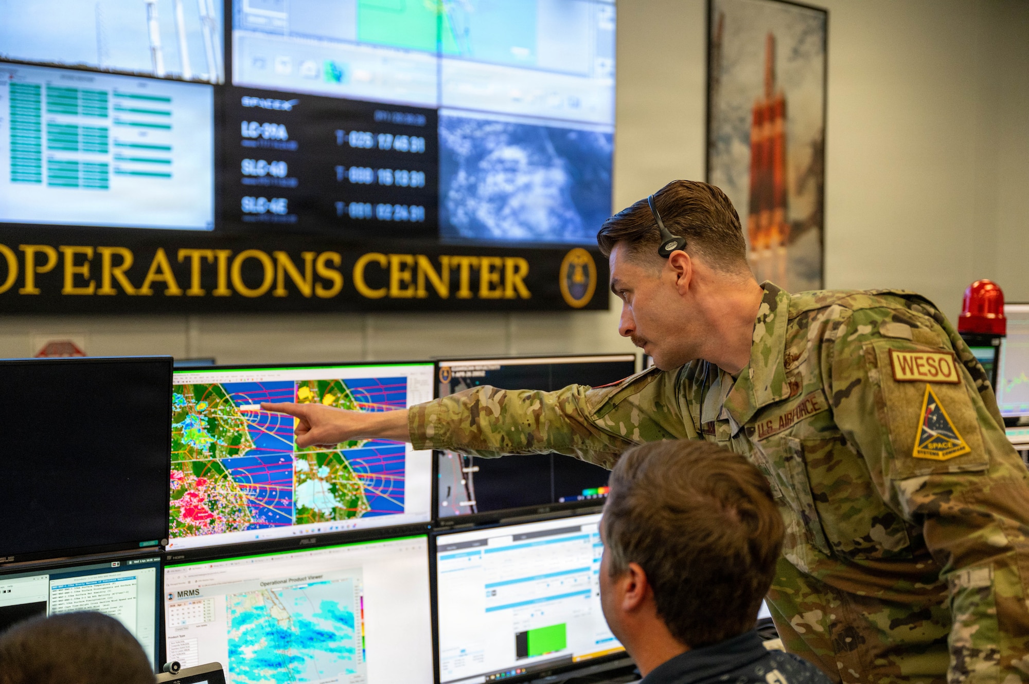 U.S. Space Force Air Force Maj. Kyle Vanyo, 45th Weather Squadron assistant director of operations points at weather diagnostics during pre launch operations at Cape Canaveral Space Force Station, Florida, April 1, 2026.