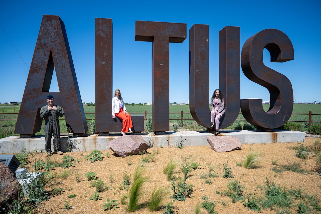 Mrs. Cindy Wilsbach, center, wife of U.S. Air Force Chief of Staff Gen. Ken Wilsbach, Dr. Doniel Wolfe, right, wife of Chief Master Sgt. of the Air Force David Wolfe, and U.S. Air Force Col. Adam Rosado, 97th Air Mobility Wing deputy commander, left, take a photo in front of the iconic Altus sign, at Altus Air Force Base, Oklahoma, April 16, 2026. During their visit, the two met with Key Support Liaisons, installation leaders and community partners to discuss quality-of-life priorities, including childcare, spouse employment, medical access and housing. They also toured the recently renovated Child Development Center to learn about best practices implemented during the project. (U.S. Air Force photo by Airman 1st Class Nathan Langston)