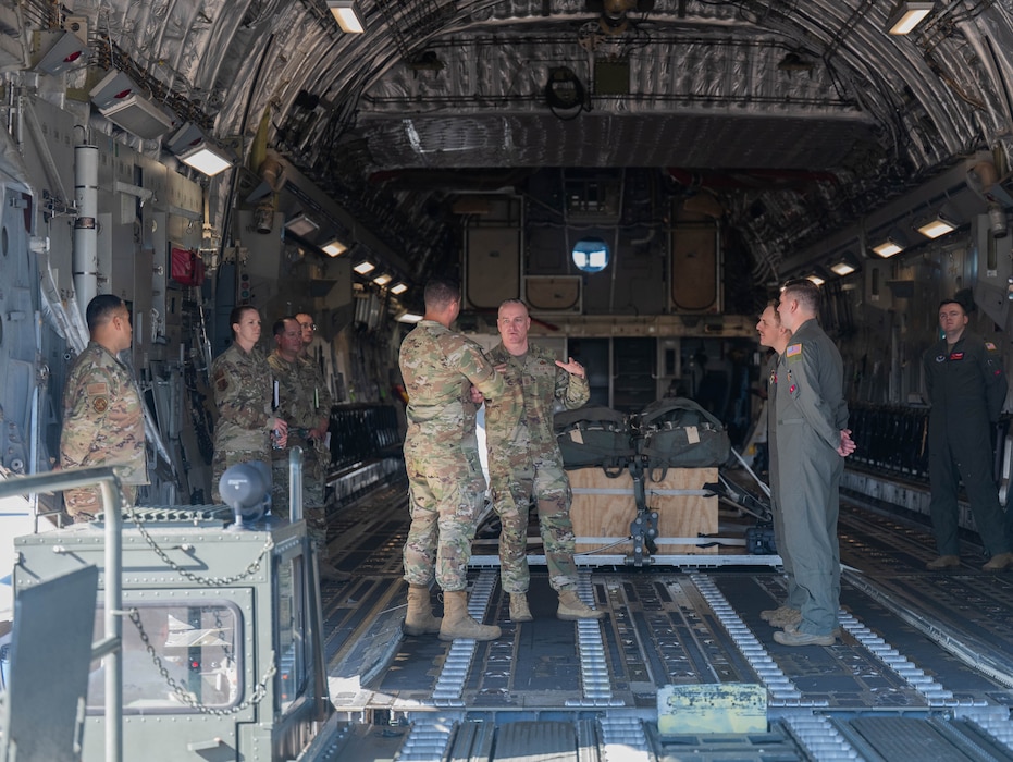 Chief Master Sgt. of the Air Force David Wolfe, visits crew members of a C-17 Globemaster III, during an immersion with the 97th Air Mobility Wing, at Altus Air Force Base, Oklahoma, April 16, 2026. The C-17 is capable of rapid strategic delivery of troops and all types of cargo to main operating bases or directly to forward bases in the deployment area. (U.S. Air Force photo by Airman 1st Class Emma Wright)