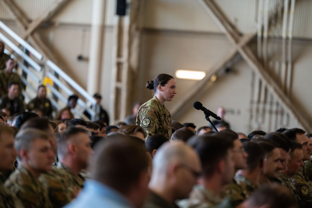 U.S. Air Force Senior Airman Emily Moran, 97th Civil Engineer Squadron fire driver operator, asks a question during an all call hosted by U.S. Air Force Chief of Staff Gen. Ken Wilsbach, and Chief Master Sgt. of the Air Force David Wolfe, speak during an immersion visit at Altus Air Force Base, Oklahoma, April 16, 2026. The all call provided an opportunity for senior leaders to connect with Airmen at every level, answer questions, and discuss the challenges and opportunities facing today’s Air Force. (U.S. Air Force photo by Tech. Sgt. Hailey Haux)