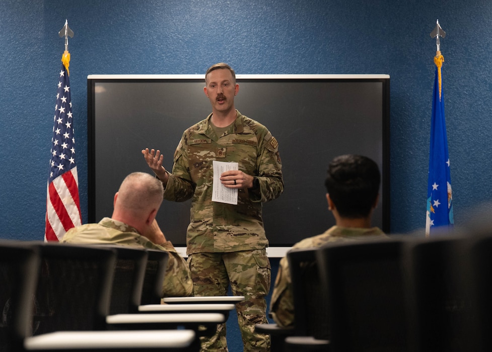 Chief Master Sgt. of the Air Force David Wolfe, left, is briefed by Master Sgt. Andrew Hayden, 97th Civil Engineer Squadron Airman Dorm Leader superintendent, during a visit to Altus Air Force Base, Oklahoma, April 16, 2026. The discussions emphasized the role Altus plays in developing the next generation of Airmen through high standards, accountability and technical excellence. (U.S. Air Force photo by Air Force photo by Airman 1st Class Emma Wright)