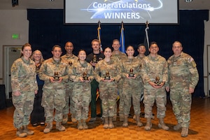 Space Launch Delta 30 members stand and pose for a group photo