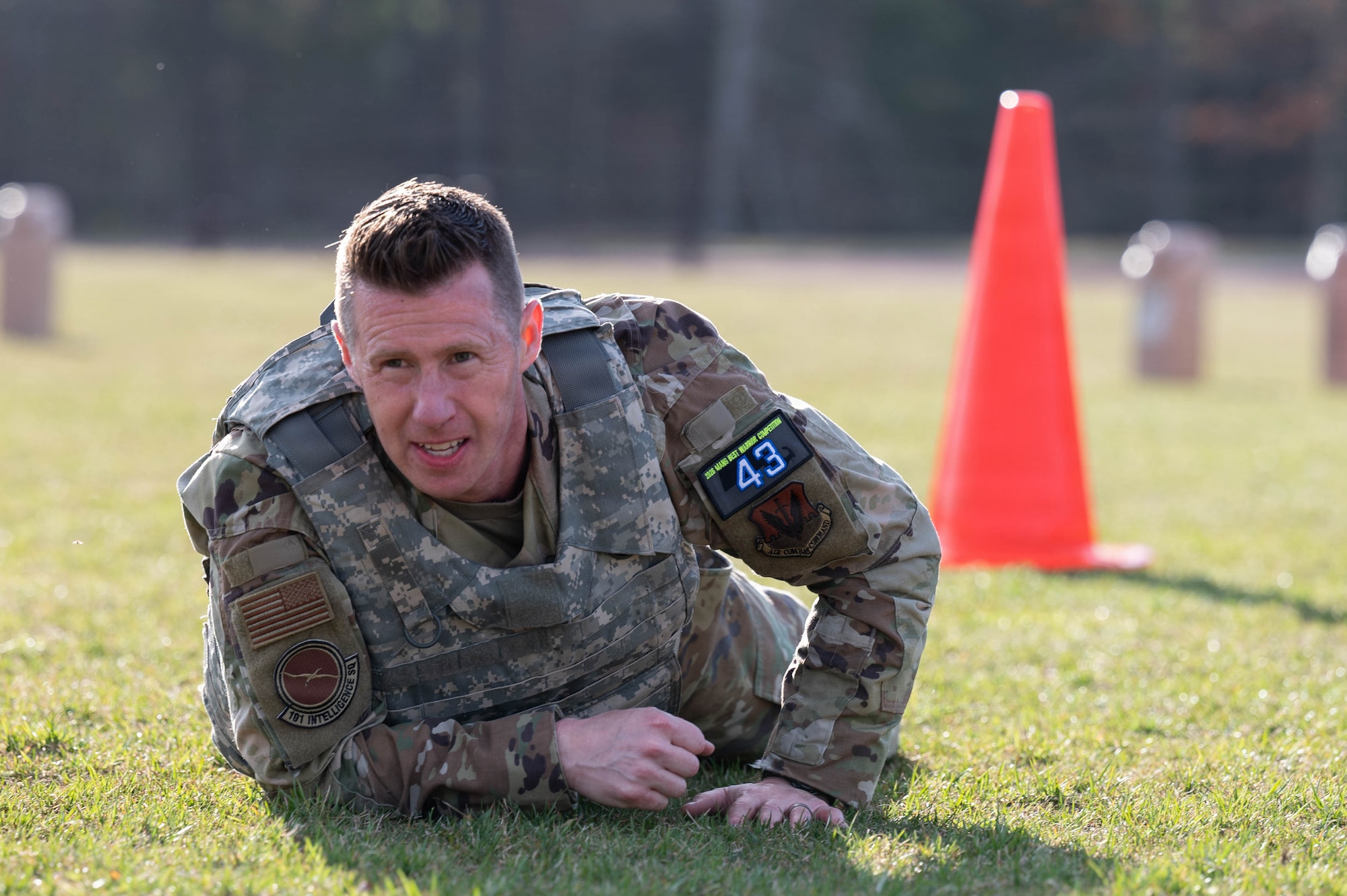 Airman high crawls on a field.