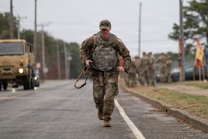 Airman runs with a ruck.