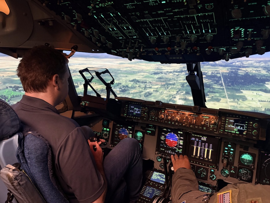 Mark Sutherland, Air Mobility Command civic leader, is led through a C-17A Flight Simulator, known as a Weapon System Trainer, at Altus Air Force Base, Oklahoma, April 9, 2026. (Courtesy photo)