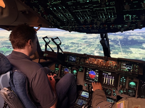 Mark Sutherland, Air Mobility Command civic leader, is led through a C-17A Flight Simulator, known as a Weapon System Trainer, at Altus Air Force Base, Oklahoma, April 9, 2026. (Courtesy photo)