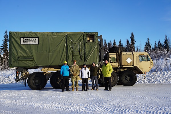 The U.S. Army Engineer Research and Development and Select Engineering Services project team standing with the Mobile Insulation System for Energy Reduction (MISER) system at Fort Wainwright, Alaska. (Photo credit: David Shields, Select Engineering Service)