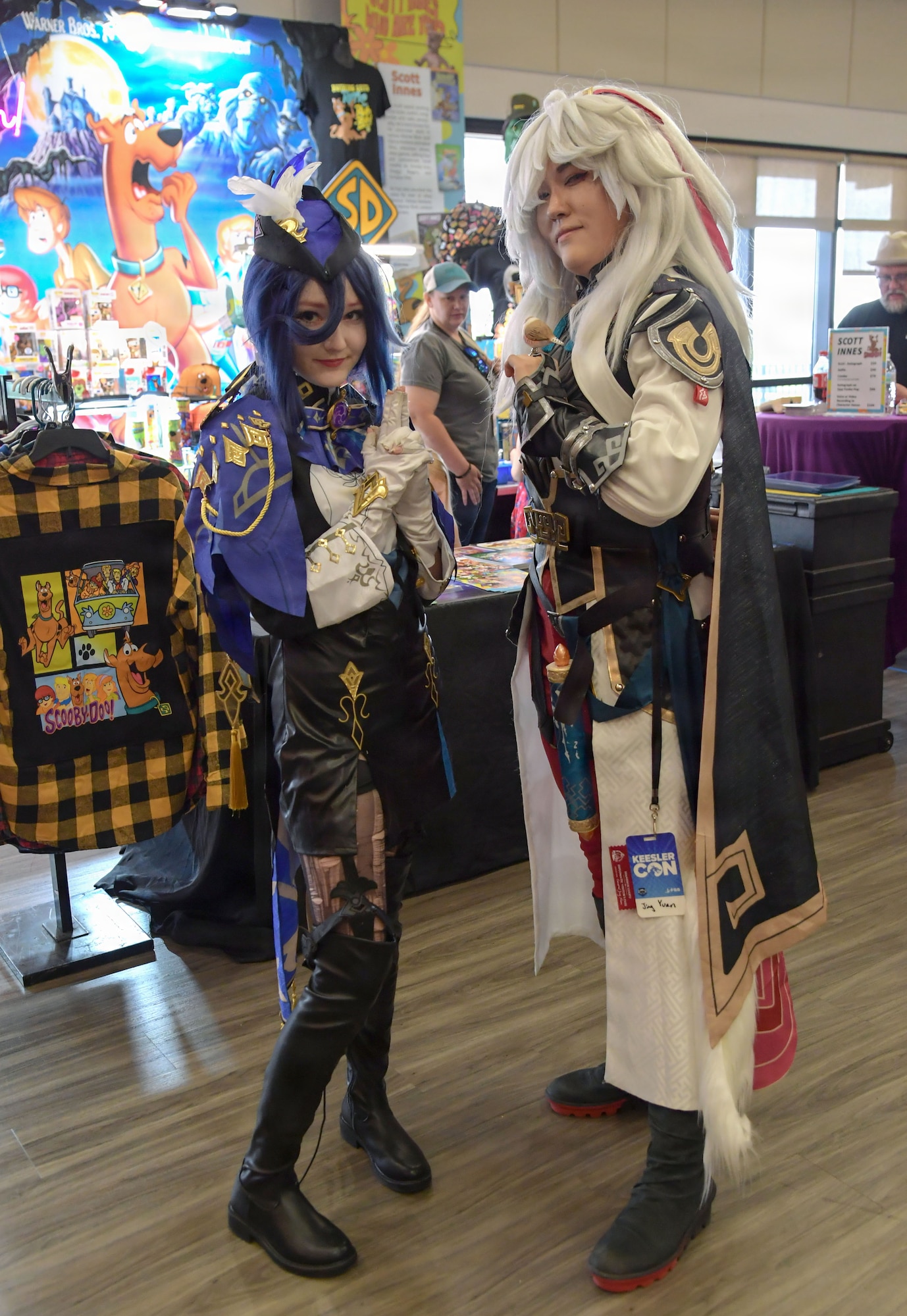 Two women wearing gaming character costumes pose for a photo.