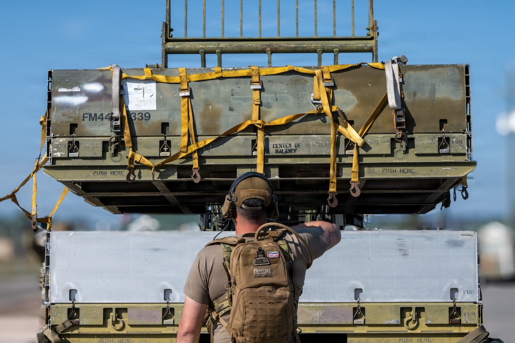 A U.S. Air Force aerial port Airman, known as “Port Dawgs,” prepares cargo for transport at Savannah Air National Guard Base, Georgia, April 23, 2026, during Exercise Ready Tiger 26-3. The exercise advanced integrated operations across multiple units, testing logistics support to deliver combat power when and where it was needed.  (U.S. Air Force photo by Staff Sgt. Sari Seibert)