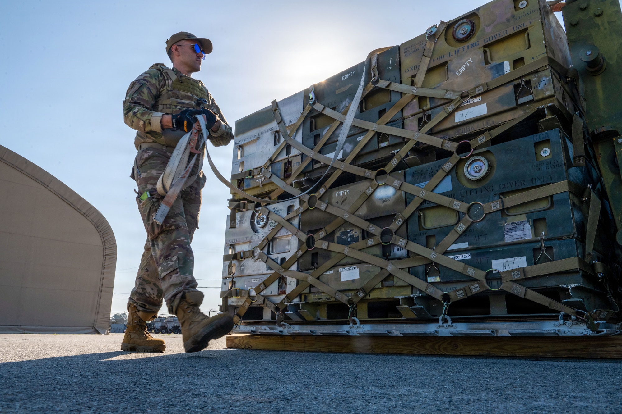 A U.S. Air Force aerial port Airman, known as “Port Dawgs,” prepares cargo for transport at Savannah Air National Guard Base, Georgia, April 23, 2026, during Exercise Ready Tiger 26-3. The exercise advanced integrated operations across multiple units, testing logistics support to deliver combat power when and where it was needed.  (U.S. Air Force photo by Staff Sgt. Sari Seibert)