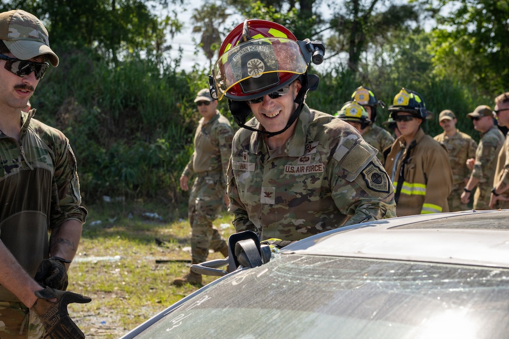 U.S. Air Force Col. Sean Hall, 23d Wing commander, uses a hydraulic rescue tool during a firefighter training event at Exercise Ready Tiger 26-3 at Savannah Air National Guard Base, Georgia, April 16, 2026. During final stages of the exercise, Hall toured the area to experience how his Airmen execute mission-essential tasks to sustain a lethal, ready force aligned with Air Combat Command priorities. (U.S. Air Force Photo by Senior Airman Iain Stanley)