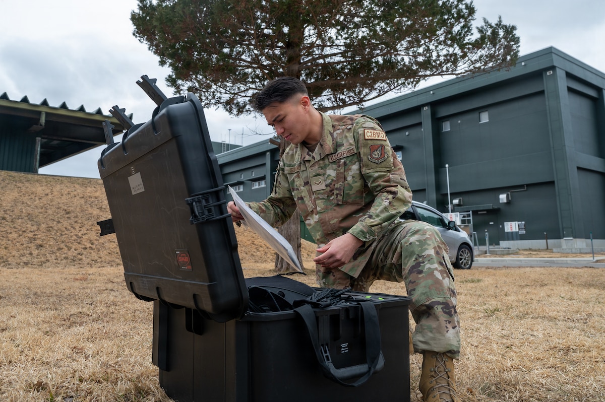 U.S. Air Force Airman 1st Class Tyler Soriano, 610th Air Control Flight (ACF) battle management technician, checks equipment at Misawa Air Base.