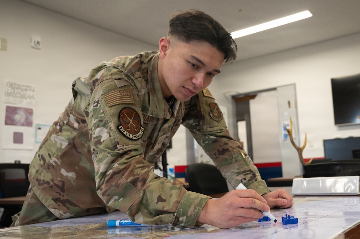 U.S. Air Force Airman 1st Class Tyler Soriano, 610th Air Control Flight (ACF) battle management technician, demonstrates how he updates information on a common operating picture map at Misawa Air Base.