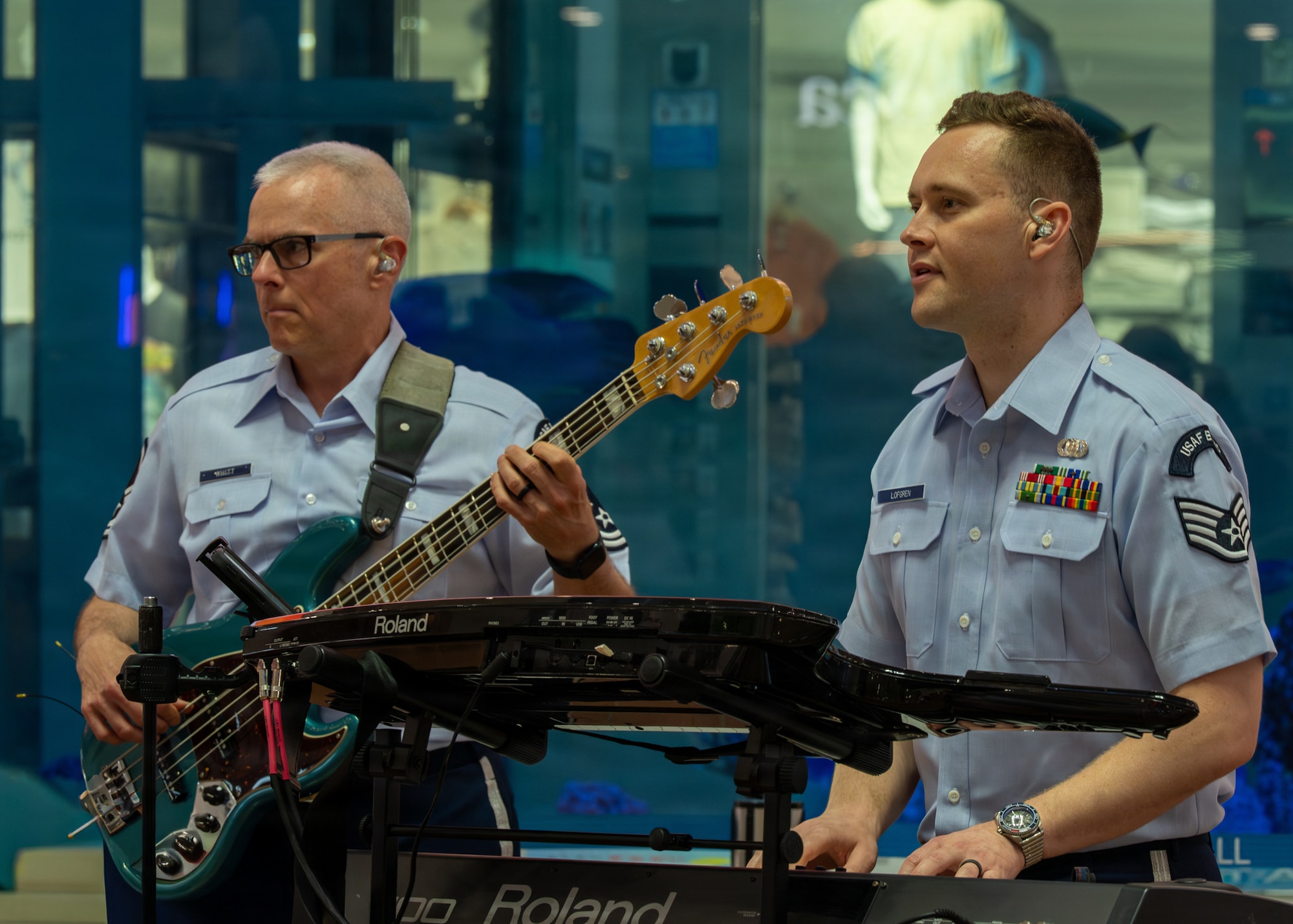U.S. Air Force Master Sgt. Joe Whitt, U.S. Air Force Band of the Pacific bass player, left, and Staff Sgt. Erik Lofgren, U.S. Air Force Band of the Pacific keyboard player, play their instruments during a performance at a local mall in Kitanakagusuku, Okinawa, April 13, 2026.