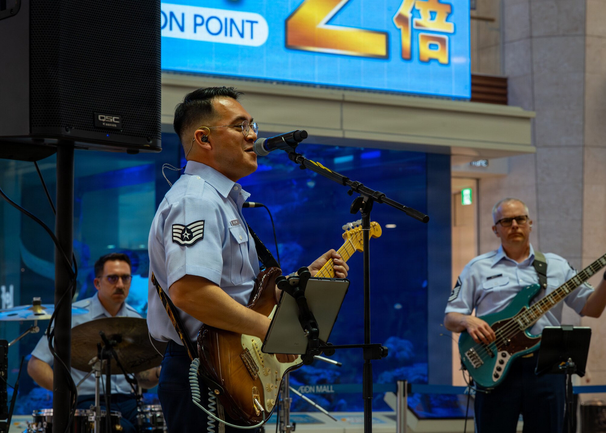 U.S. Air Force Staff Sgt. Christopher Arellano, U.S. Air Force Band of the Pacific guitarist, sings during a performance at a local mall in Kitanakagusuku, Okinawa, April 13, 2026.