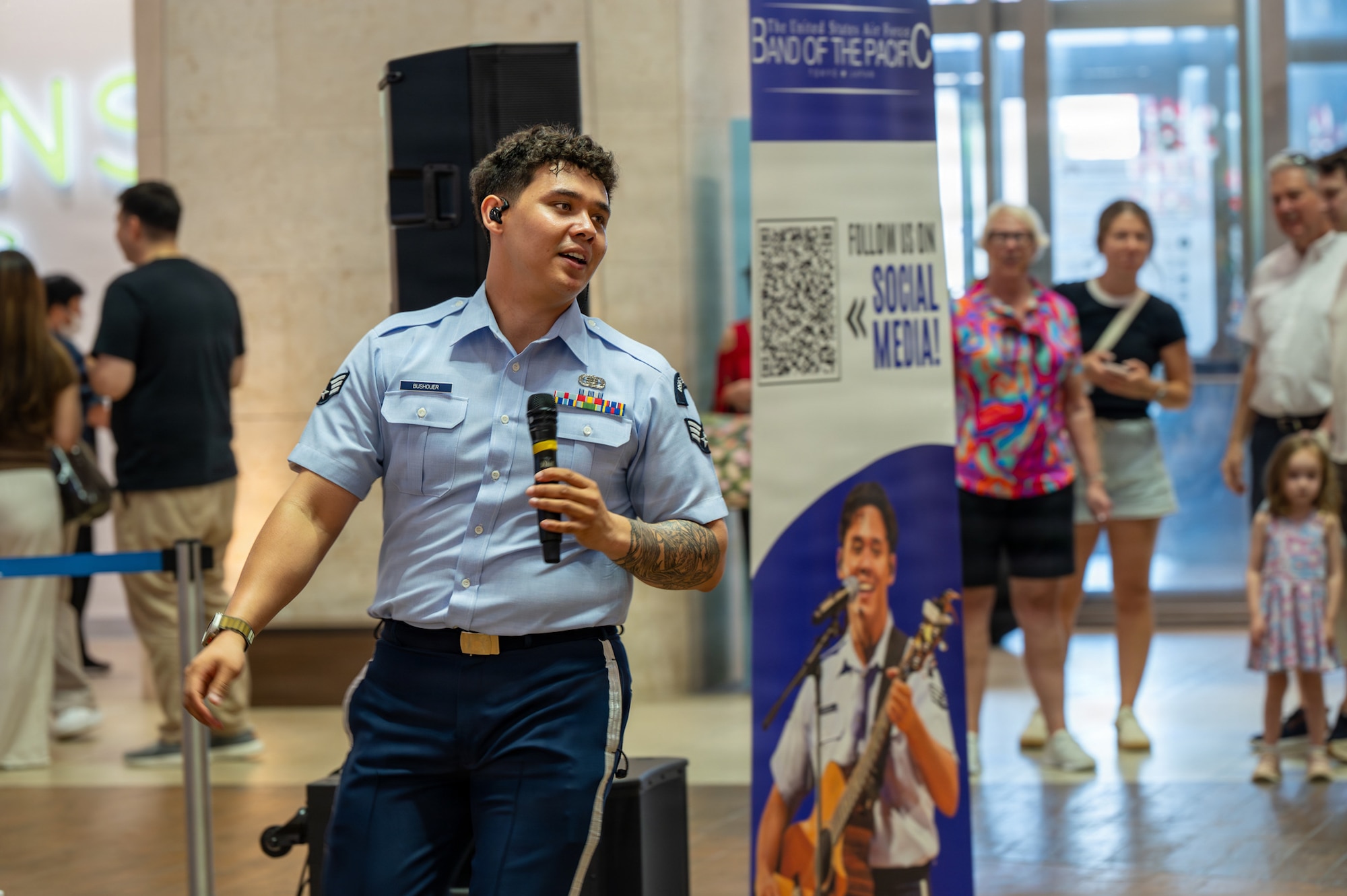 U.S. Air Force Senior Airman Keegan Bushouer, U.S. Air Force Band of the Pacific vocalist, sings for members of the community during a show at a local mall in Kitanakagusuku, Okinawa, April 13, 2026.