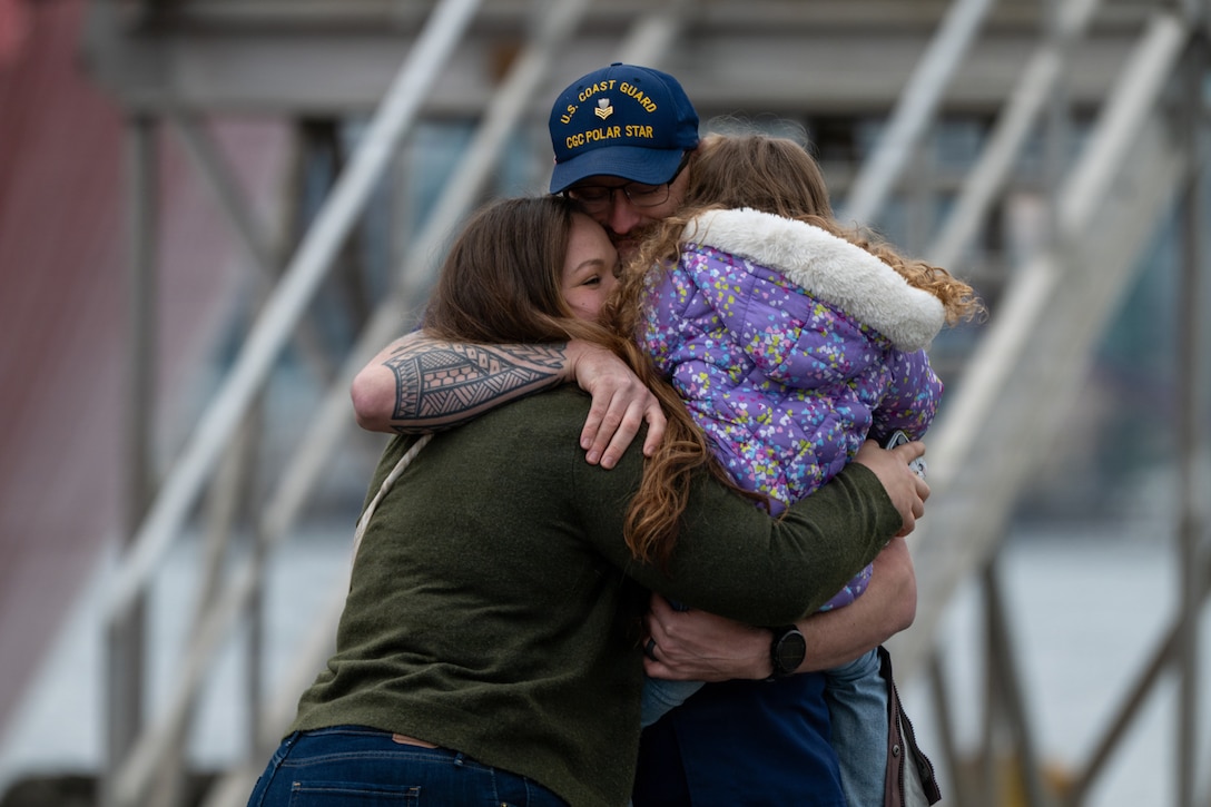 A U.S. Coast Guard Cutter Polar Star (WAGB 10) crewmember reunites with his family at Coast Guard Base Seattle following a 146-day Antarctic deployment in support of Operation Deep Freeze, April 13, 2026. The Polar Star is the United States' only surface asset capable of providing year-round access to both Polar Regions. It is a 399-foot heavy polar icebreaker commissioned in 1976, weighing 13,500 tons and is 84 feet wide with a 34-foot draft. (U.S. Coast Guard photo by Petty Officer 2nd Class Briana Carter)