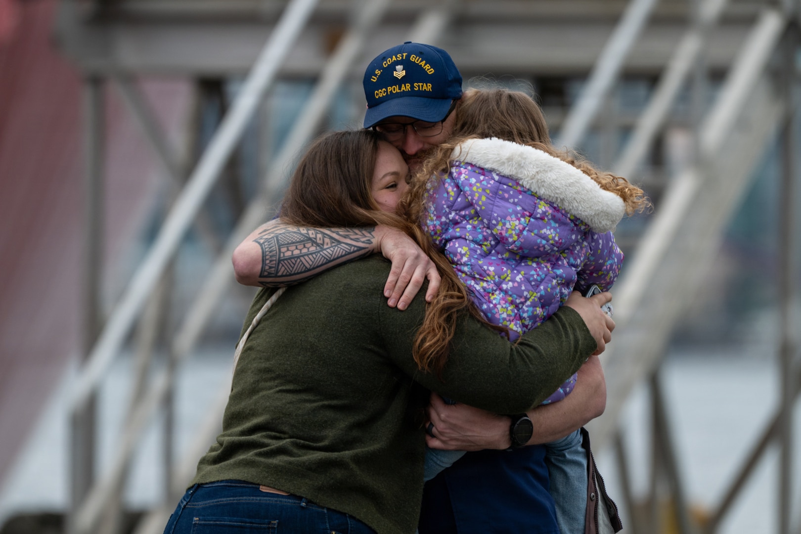 A U.S. Coast Guard Cutter Polar Star (WAGB 10) crewmember reunites with his family at Coast Guard Base Seattle following a 146-day Antarctic deployment in support of Operation Deep Freeze, April 13, 2026. The Polar Star is the United States' only surface asset capable of providing year-round access to both Polar Regions. It is a 399-foot heavy polar icebreaker commissioned in 1976, weighing 13,500 tons and is 84 feet wide with a 34-foot draft. (U.S. Coast Guard photo by Petty Officer 2nd Class Briana Carter)