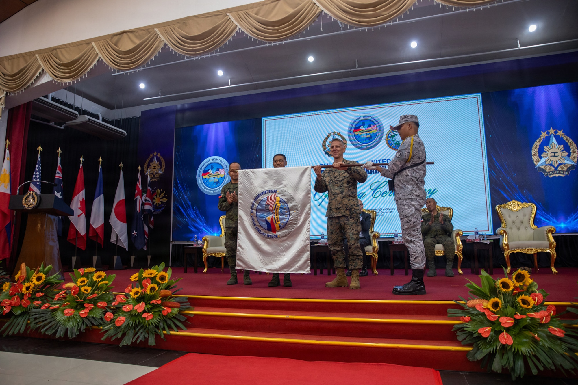 From left to right, Philippine Army Maj. Gen Franscisco F. Lorenzo Jr, Philippine exercise director, Gen. Romero S. Brawner Jr., Chief of Staff of the Armed Forces of the Philippines, and U.S. Marine Corps Lt. Gen. Christian F. Wortman, commanding general of the U.S. joint task force, unfurl the Exercise Balikatan 2026 flag during the opening ceremony at Camp General Emilio Aguinaldo, Manila, Philippines, April 20, 2026. Balikatan is a longstanding annual exercise between the AFP and U.S. military designed to strengthen our ironclad alliance, improve our capable combined force, and demonstrate our commitment to regional security and stability (U.S. Army photo by Sgt. Sar Paw)