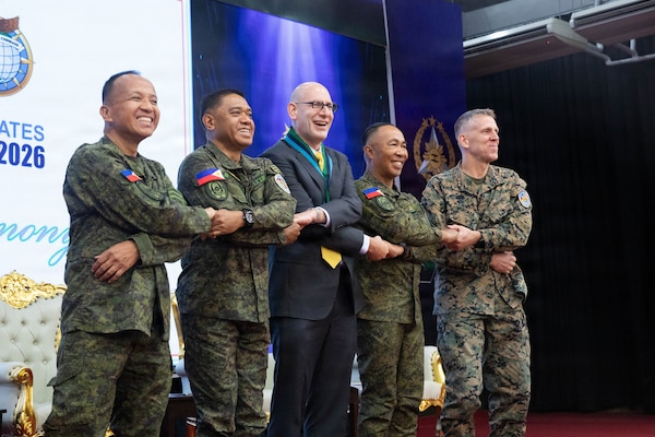 From left to right, Philippine Army Maj. Gen Franscisco F. Lorenzo Jr, Philippine exercise director, Gen. Romero S. Brawner Jr., Chief of Staff of the Armed Forces of the Philippines, and U.S. Marine Corps Lt. Gen. Christian F. Wortman, commanding general of the U.S. joint task force, unfurl the Exercise Balikatan 2026 flag during the opening ceremony at Camp General Emilio Aguinaldo, Manila, Philippines, April 20, 2026.