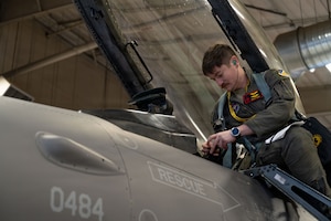 U.S. Air Force Maj. Timothy Goff, 8th Fighter Squadron pilot, enters the cockpit of an F-16 Fighting Falcon to perform a preflight check at Holloman Air Force Base