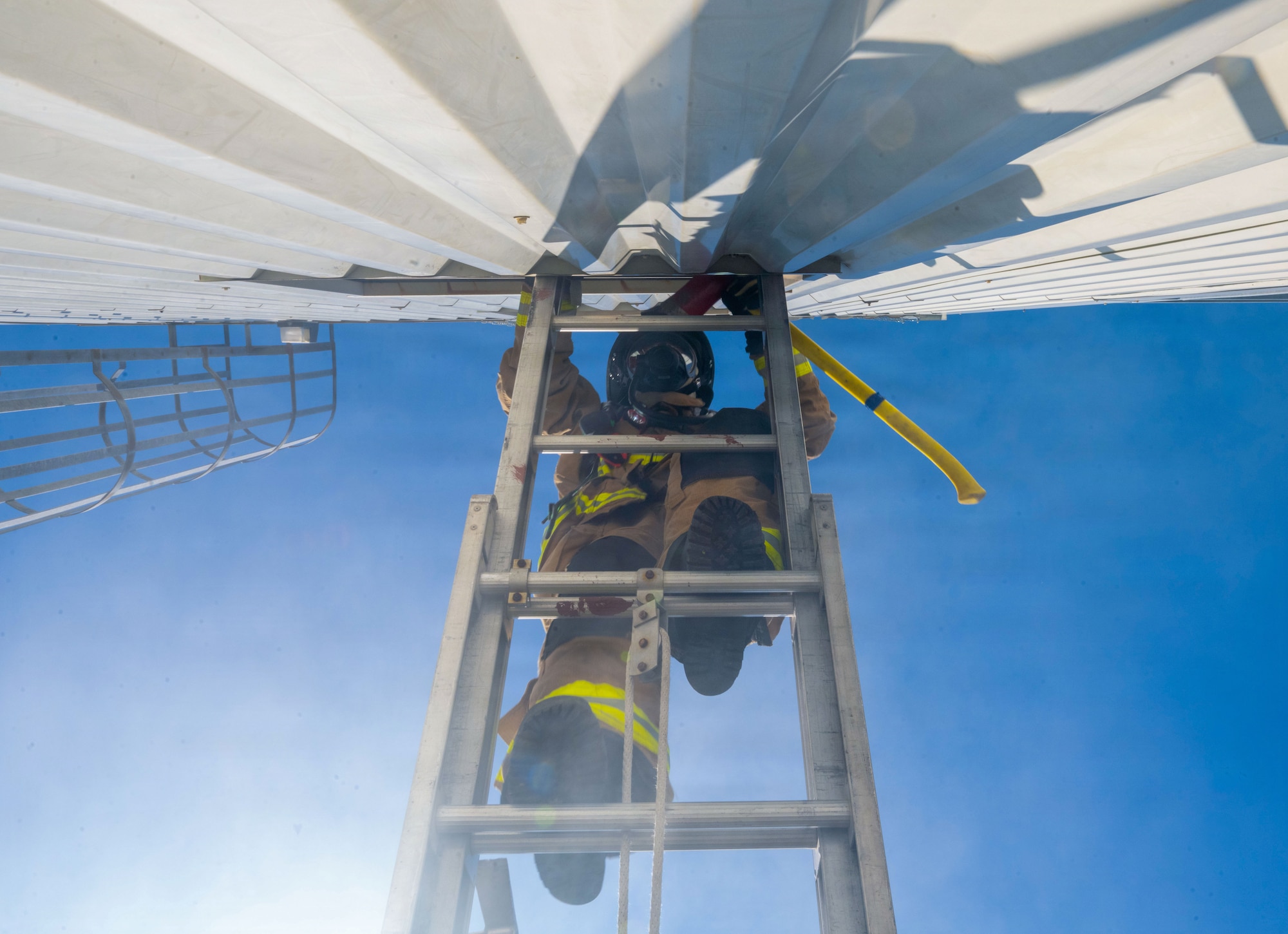 A U.S. Air Force Airman from the 23d Civil Engineer Squadron ascends a ladder to access a second-story window during a simulated house fire search and rescue training event at Savannah Air National Guard Base, Georgia, April 22, 2026, as part of Exercise Ready Tiger 26-                                  3. Airmen demonstrated disciplined execution and accountability, key to maintaining Air Force standards and readiness. (U.S. Air Force photo by Staff Sgt. Sari Seibert)