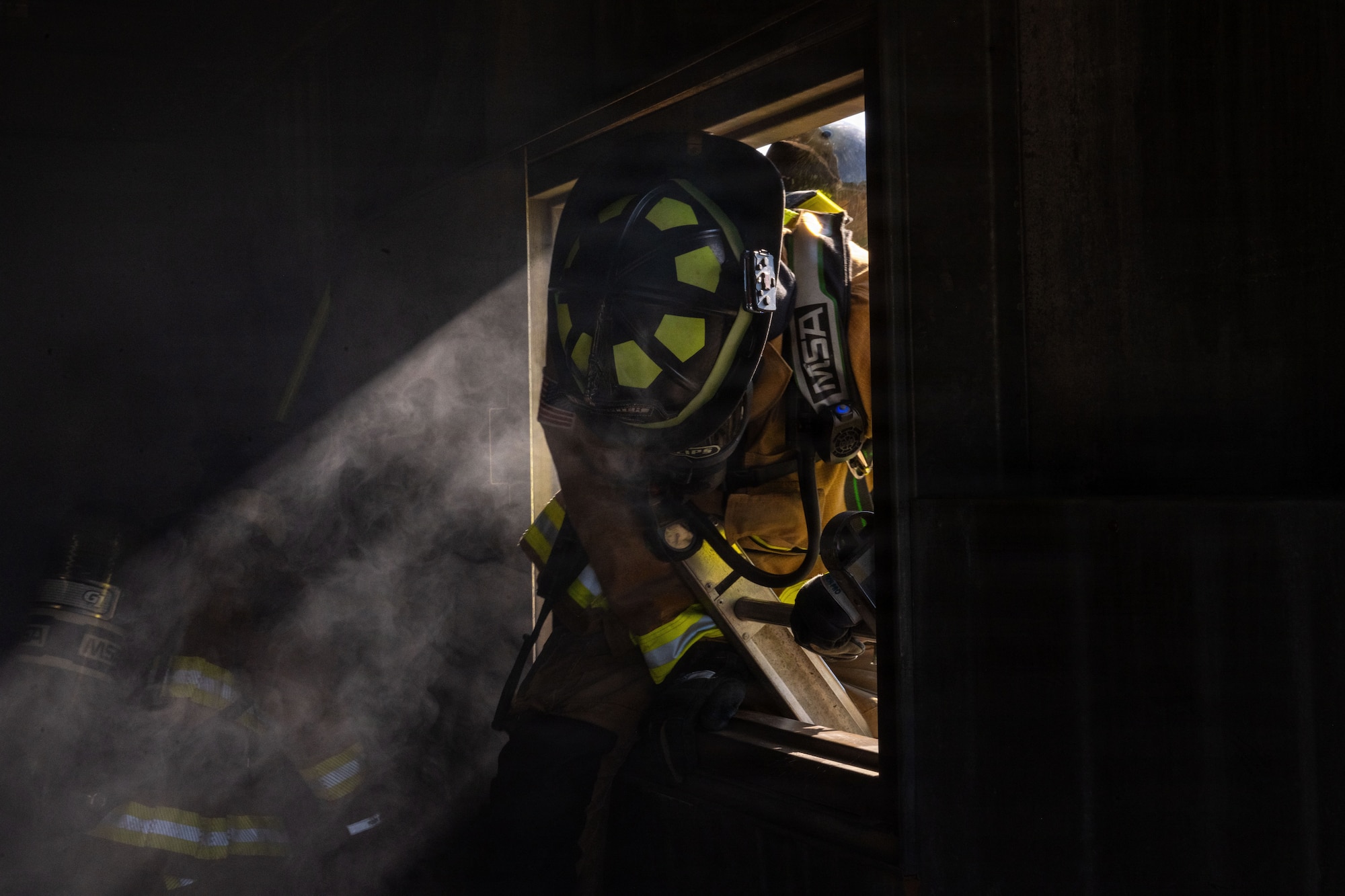 A U.S. Air Force Airman from the 23d Civil Engineer Squadron conducts a simulated second-story window entry during a search and rescue training event at Savannah Air National Guard Base, Georgia, April 22, 2026, as part of Exercise Ready Tiger 26-3. The training emphasized mission command, empowering leaders to make timely decisions in dynamic scenarios. (U.S. Air Force photo by Staff Sgt. Sari Seibert)