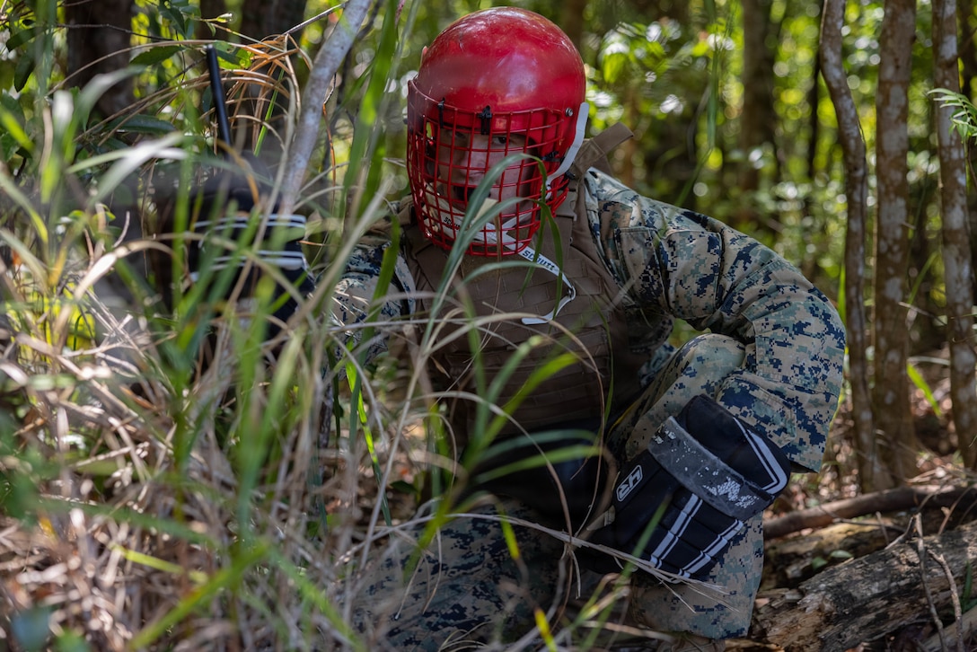 U.S. Marine Corps Cpl. John Simpson, a combat graphics specialist with Headquarters Battalion, 3rd Marine Division, hides during a field training exercise on Camp Hansen, Okinawa, Japan, April 8, 2026. The COMMSTRAT FTX is a five-day event focused on increasing acumen and technical proficiency to provide commanders with capable COMMSTRAT forces at the tactical level. Simpson is a native Arkansas. (U.S. Marine Corps photo by Lance Cpl. Carlos Paz-Sosa)