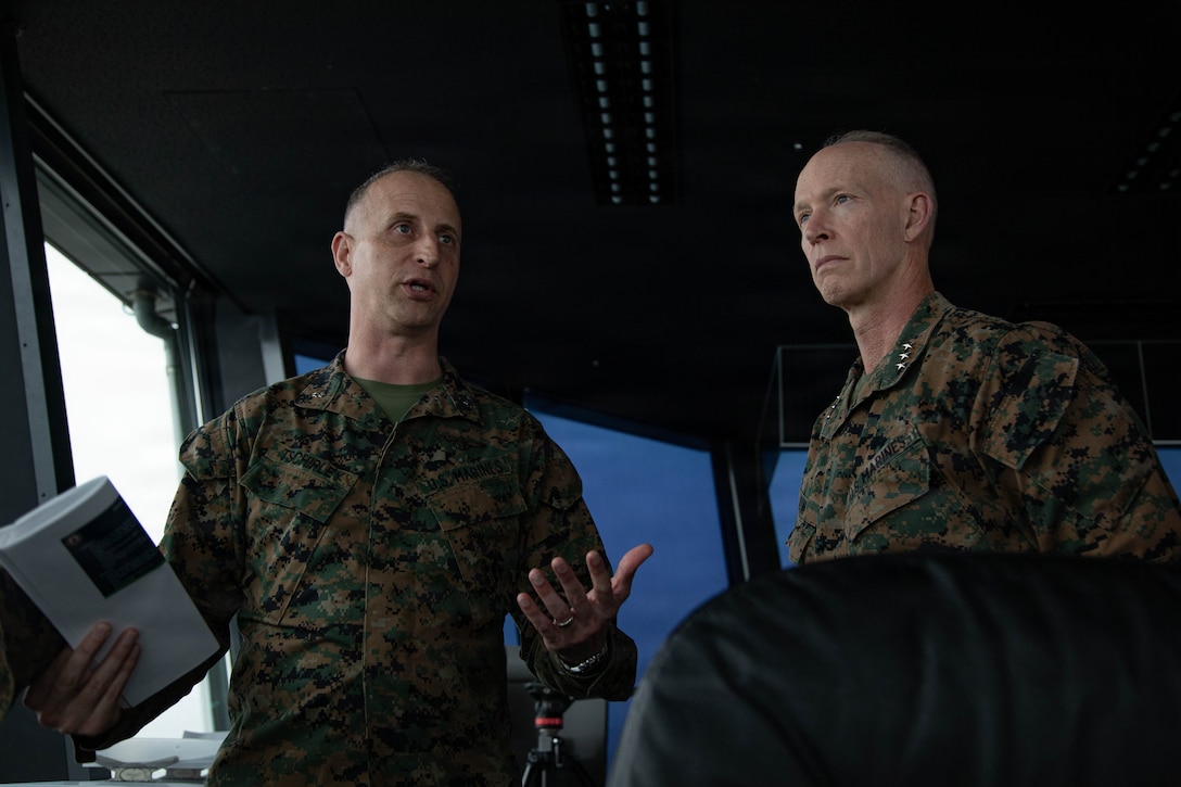 U.S. Marine Corps Lt. Gen. James Glynn, right, the commander of U.S. Marine Corps Forces Pacific, a native of Albany, New York, and Lt. Col. Devon Tschirley, station executive officer, Marine Corps Air Station Iwakuni, and native of Spokane, Washington speak to each other during a base tour at MCAS Iwakuni, Japan, April 1, 2026. Leadership from MARFORPAC; Marine Aircraft Group 12, 1st Marine Air Wing, and MCAS Iwakuni were given a tour of the air station to learn more about its capabilities. (U.S. Marine Corps photo by Sgt. Peter Rawlins)