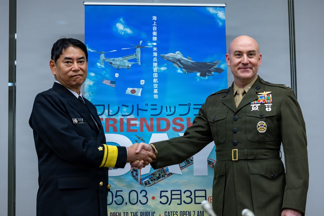 Japan Maritime Self-Defense Force Rear Admiral Katsushi Ohkubo, left, the commander of Fleet Air Wing 31, and U.S. Marine Corps Col. Kenneth Rossman, the commanding officer of Marine Corps Air Station Iwakuni and a native of Pennsylvania, shake hands during the Friendship Day 26 press conference at Iwakuni City Hall, Japan, April 13, 2026. The press conference was held to address questions, concerns or comments from local media outlets about the annual Friendship Day event. (U.S. Marine Corps photo by Cpl. Dahkareo Pritchett)