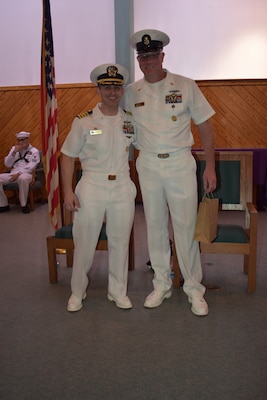 Capt. Christopher Barnes and HMCM Brandon Lindbeck share a moment before the close of the ceremony.