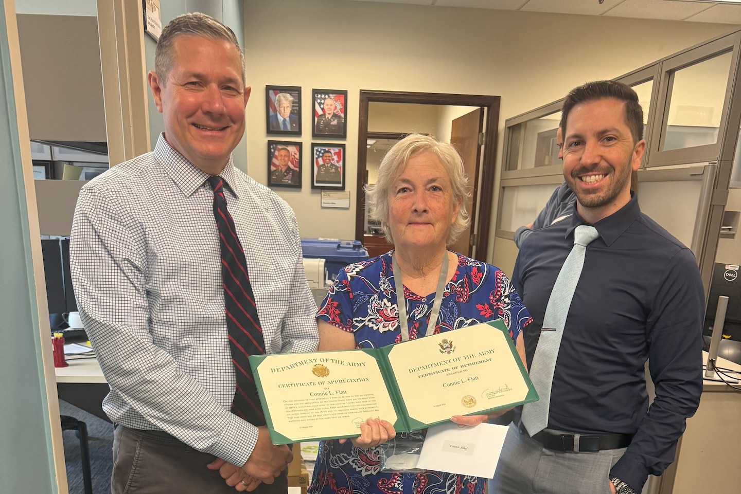 Craig Carrington (Left), Nashville District deputy for Project Management, presents the Department of the Army Certificate of Retirement March 31, 2026, to Connie Flatt, Operations and Maintenance Program manager, on behalf of Lt. Col. Guillermo Guandique, Nashville District commander. Anthony Rodino, chief of Programs and Project Delivery Branch and deputy DPM, joins the presentation to congratulate her on culminating 46 years of federal service. She recently culminated 46 years of federal service during a retirement ceremony March 31, 2026. (USACE Photo) (USACE Photo by Maritere Cornelius)