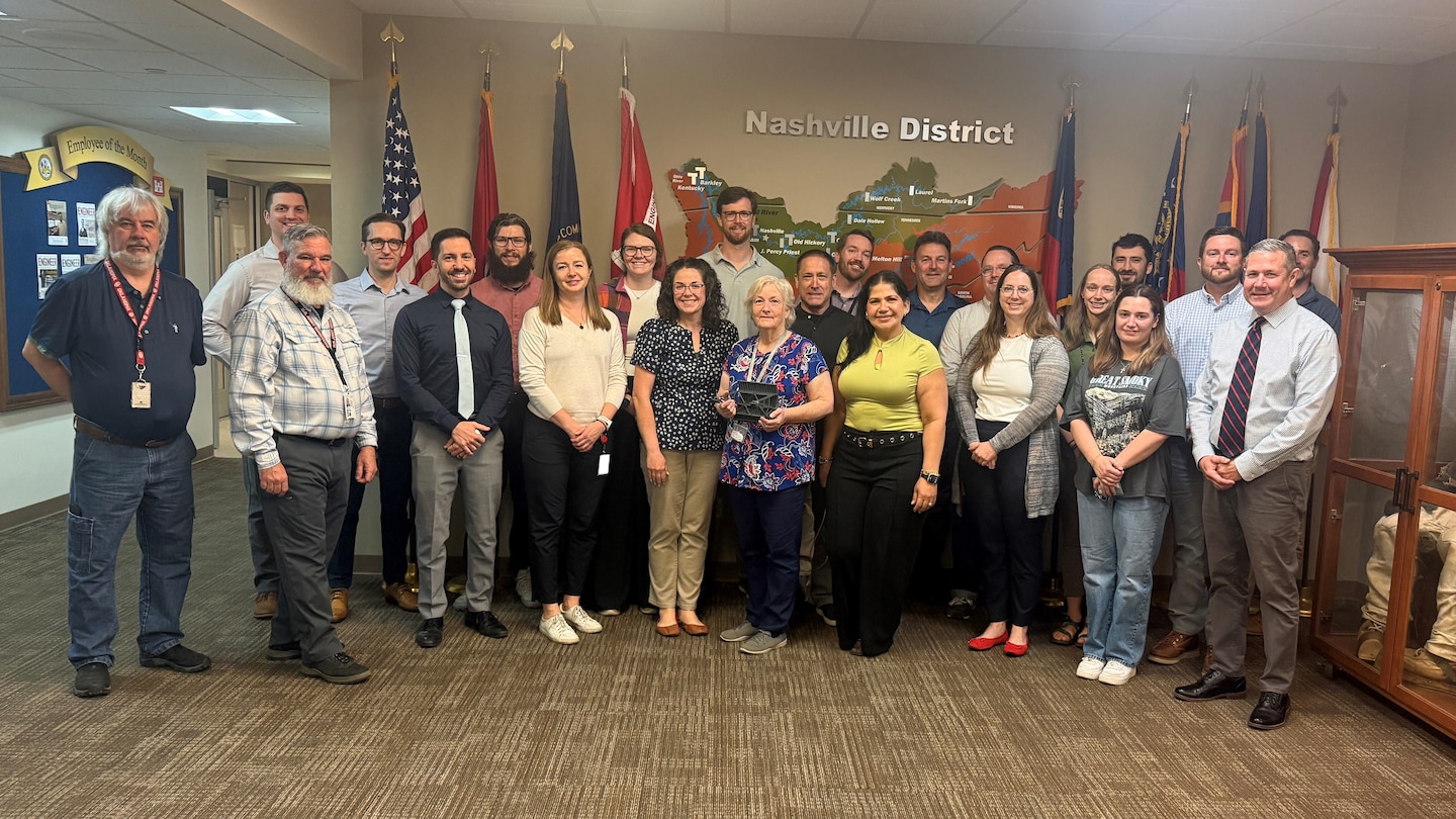 Connie Flatt (Center front row) holds a model spillway gate and poses the day of her retirement with coworkers at the U.S. Army Corps of Engineers Nashville District Headquarters. She culminated  46 years of federal service March 31, 2026. (USACE Photo by Travieyon Barge)