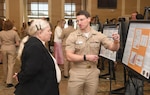 Navy Lt. Robert Goldin with the NMCCL Family Medicine Residency Program discusses his research poster ta NMCCL's Annual Research Symposium. The symposium, held on April 16, 2026, is in its 16th year of showcasing academic endeavors of medical and dental personnel, both military and civilian throughout Eastern and Coastal North Carolina.