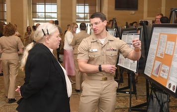 Navy Lt. Robert Goldin with the NMCCL Family Medicine Residency Program discusses his research poster ta NMCCL's Annual Research Symposium. The symposium, held on April 16, 2026, is in its 16th year of showcasing academic endeavors of medical and dental personnel, both military and civilian throughout Eastern and Coastal North Carolina.