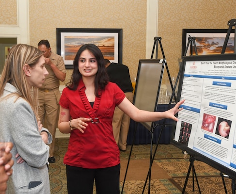 Aaditi Kulkarni with the Campbell University School of Osteopathic Medicine discusses her research poster at the Naval Medical Center Camp Lejeune Annual Research Symposium on April 16, 2026. The event showcases academic endeavors of medical and dental personnel, both military and civilian throughout Eastern and Coastal North Carolina.