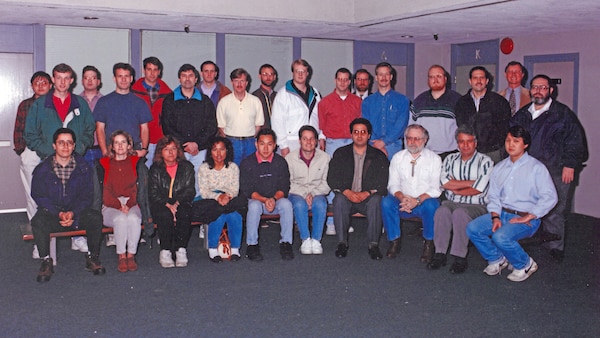 Connie Flatt (Front Row, Second from Left), poses with coworkers March 15, 1996, at the Nashville District Headquarters in Nashville, Tennessee. She recently culminated 46 years of federal service during a retirement ceremony March 31, 2026. (USACE Photo)