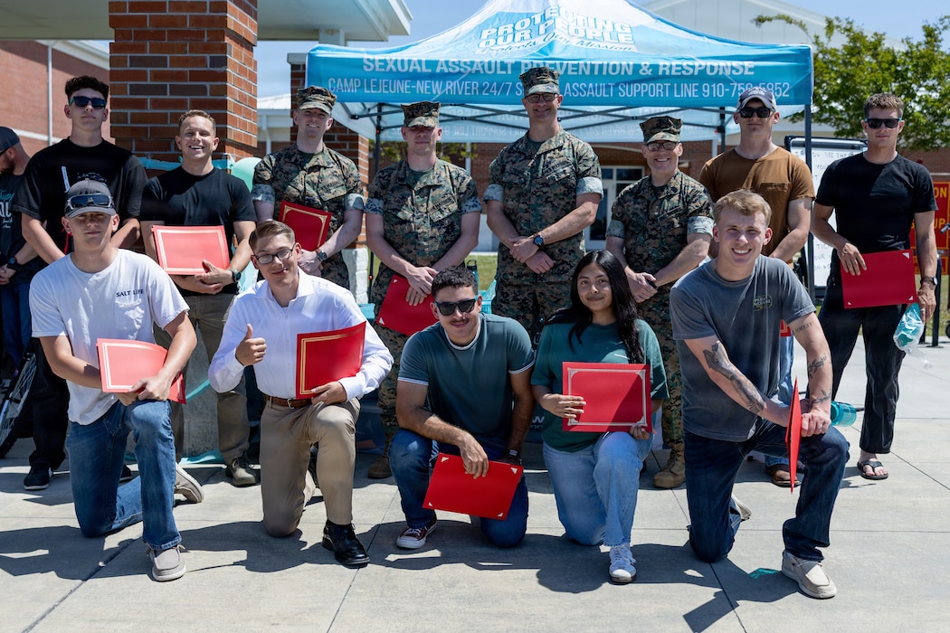 U.S. Marines with II Marine Expeditionary Force Information Group pose for a photograph during a Sexual Assault Prevention and Response event on Marine Corps Base Camp Lejeune, North Carolina, April 17, 2026. SAPR coordinators hosted this event during Sexual Assault Awareness Month to encourage military members to raise awareness and understand how to prevent, report and advocate for survivors.  (U.S. Marine Corps Lance Cpl. Dorian Melrath)