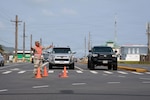 Guam National Guardsman Staff Sgt. Ignacio Cabrera, fire support sergeant, Guam Army National Guard, directs traffic in Maite, Guam, April 18, 2026. Guam National Guardsmen, alongside local law enforcement authorities and first responders, set up traffic control points at various locations experiencing power outages because of damage from Typhoon Sinlaku. Photo by Senior Airman Natasha Ninete.
