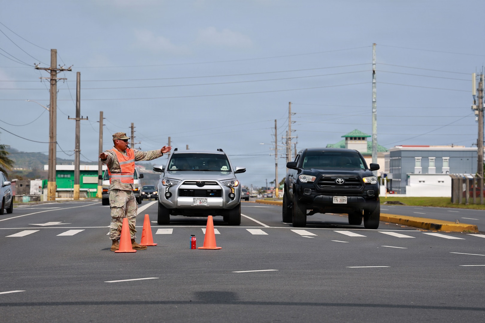 Guam National Guardsman Staff Sgt. Ignacio Cabrera, fire support sergeant, Guam Army National Guard, directs traffic in Maite, Guam, April 18, 2026. Guam National Guardsmen, alongside local law enforcement authorities and first responders, set up traffic control points at various locations experiencing power outages because of damage from Typhoon Sinlaku.