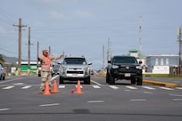 Guam National Guardsman Staff Sgt. Ignacio Cabrera, fire support sergeant, Guam Army National Guard, directs traffic in Maite, Guam, April 18, 2026. Guam National Guardsmen, alongside local law enforcement authorities and first responders, set up traffic control points at various locations experiencing power outages because of damage from Typhoon Sinlaku.
