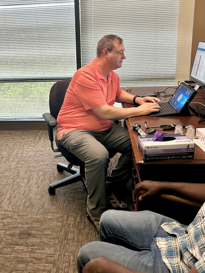 Dr. Brian Piltz, USMEPCOM Western Sector medical officer, processes an applicant during a MEPS in a Box popup in Orlando, Fla. Dr. Piltz brings a uniquely diverse background to guide operations, mentor providers and support the mission with a hands-on, problem-solving approach.