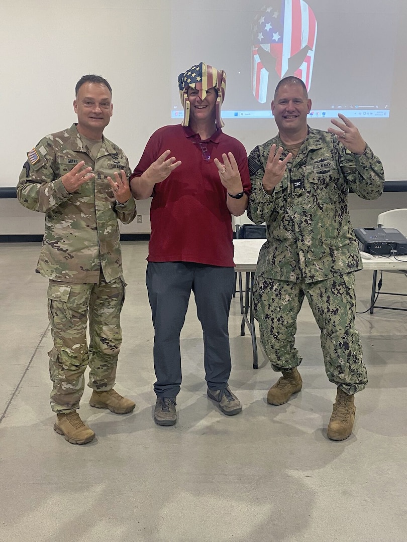 (Center) Dr. Brian Piltz, USMEPCOM Western Sector medical officer, shows off his Western Sector Warrior spirit with Army Command Sgt. Maj. David Goins, Western Sector senior enlisted advisor, and Navy Capt. Christopher Carmichael, Western Sector commander, during s MEPS in a Box popup in Fresno, Calif. Dr. Piltz brings a uniquely diverse background to guide operations, mentor providers and support the mission with a hands-on, problem-solving approach.