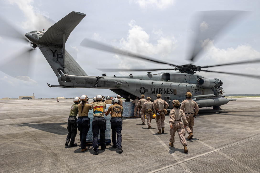 U.S. Marines with Combat Logistics Battalion 11, 11th Marine Expeditionary Unit, and Sailors with Helicopter Sea Combat Squadron (HSC) 25, load pallets of water bottles onto a CH-53E Super Stallion assigned to Marine Medium Tiltrotor Squadron (VMM) 163 (Reinforced), 11th MEU, at Andersen Air Force Base in Guam, April 18, 2026. The 11th MEU, embarked aboard the Boxer Amphibious Ready Group, is providing vital defense support to civil authorities, contributing to crisis response and recovery efforts in the wake of Super Typhoon Sinlaku. In supporting FEMA and local governments, the 11th MEU fills critical capability gaps to enable restoration of essential services by civil authorities