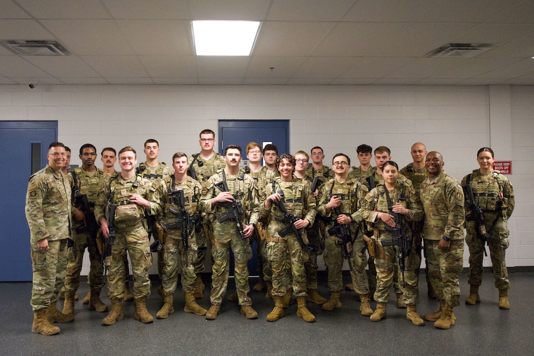 Security Forces Airmen stand in formation indoors with two senior leaders after a guard mount at Wright-Patterson Air Force Base.