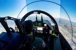 U.S. Air Force Lt. Col. Michael Piazza, 99th Flying Training Squadron, T-7A test weapon systems officer, pilots the T-7A Red Hawk ground-based training system in a full-scale simulation at Joint Base San Antonio-Randolph, Texas, April 2, 2026. Piazza tested the GBTS, which features six degrees of freedom and a user interface identical to the aircraft. The system was used to evaluate performance, realism and training effectiveness during functional mission testing. (U.S. Air Force photo by Zelideth Rodriguez)