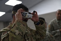 U.S. Air Force Master Sgt. Charles Rodriguez, Hap Arnold Innovation Center, California Air National Guard, tries on First-Person View goggles for small Unmanned Aerial Systems during a Defense Contract Management Agency, or DCMA, Blue List training event, March Air Reserve Base, Calif., April 14, 2026.