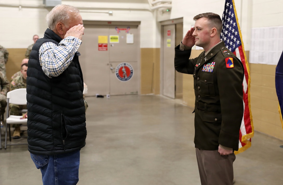 Larry Marcum renders the first salute to his grandson, U.S. Army Warrant Officer Elijah Johnson during his appointment ceremony, Feb. 10, 2026 in Lexington, Kentucky.