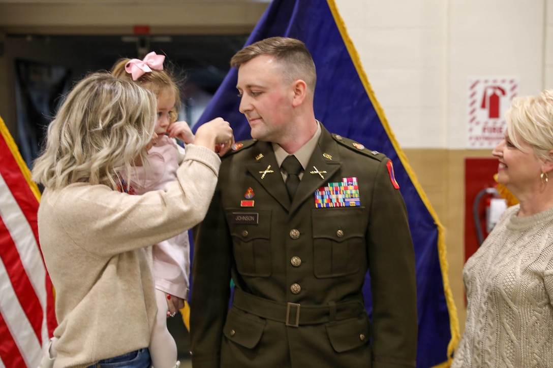 U.S. Army Warrant Officer Elijah Johnson is pinned by his wife, Samijo, daughter, Mallory, and mother, Kim during his appointment ceremony, Feb. 10, 2026 in Lexington, Kentucky.