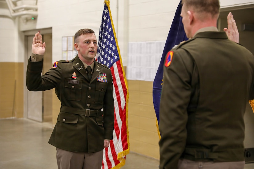 U.S. Army Col. Robert Andersen, commander of the 138th Operational Fires Command, administers the Oath of Office to Warrant Officer Elijah Johnson during his appointment ceremony at the armory in Lexington, Kentucky, Feb. 10, 2026.